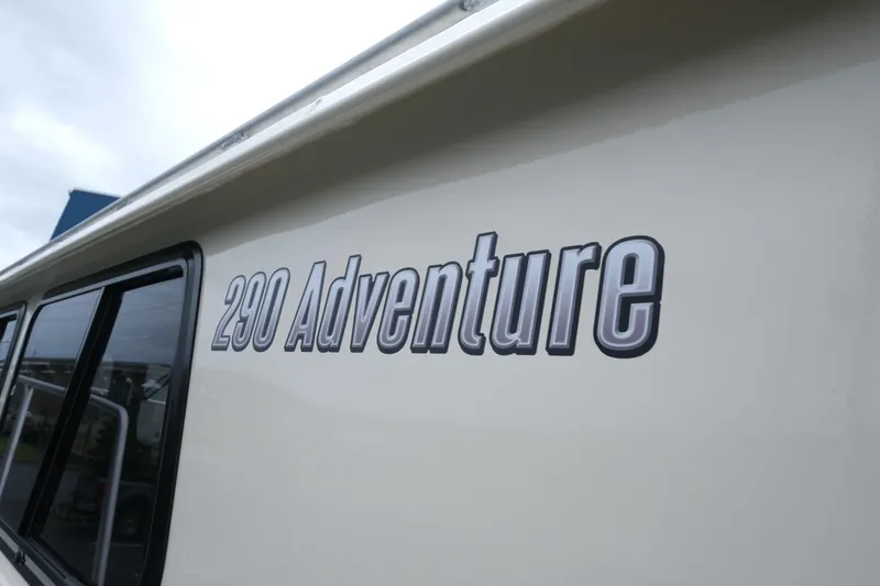 Slide: The Image of 2025 Hewescraft 290 Adventure boat side view with logo. - 6