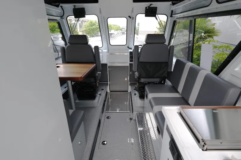 Slide: The Image of Interior of 2025 Hewescraft 270 Alaskan boat, featuring seating and a table. - 11
