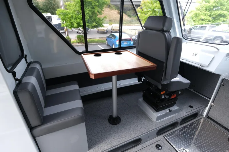 Slide: The Image of Interior of 2025 Hewescraft 270 Alaskan boat with seating and table. - 12