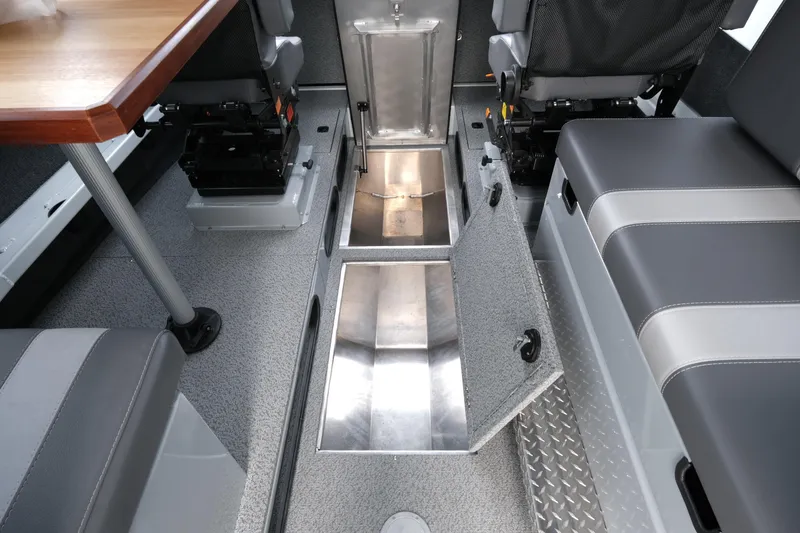 Slide: The Image of 2025 Hewescraft 270 Alaskan interior with open storage compartments and seating. - 20