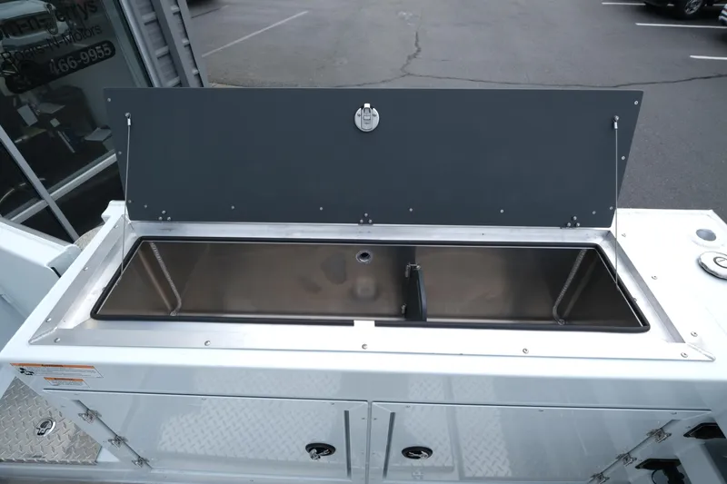 Slide: The Image of Open storage compartment on 2025 Hewescraft 270 Alaskan boat, showcasing sleek design. - 22