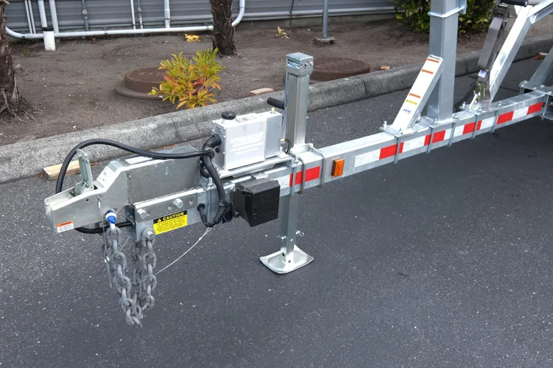Slide: The Image of Trailer hitch and chains for 2025 Hewescraft 270 Alaskan boat on asphalt surface. - 7
