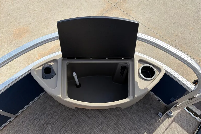 Slide: The Image of 2025 Sun Tracker Bass Buggy 18 DLX boat storage compartment with cup holder and rod holder. - 13