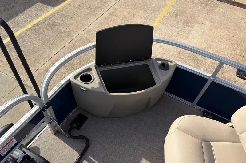 Slide: The Image of 2025 Sun Tracker Bass Buggy 18 DLX boat interior with storage compartment and cup holder. - 15