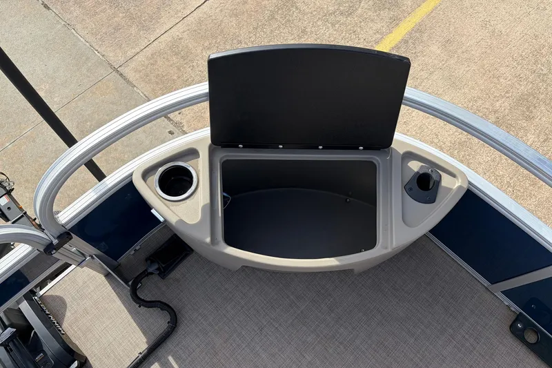 Slide: The Image of 2025 Sun Tracker Bass Buggy 18 DLX boat storage compartment with cup holder. - 16