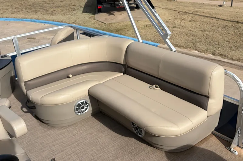 Slide: The Image of 2025 Sun Tracker Bass Buggy 18 DLX pontoon boat with beige seating and speaker system. - 20