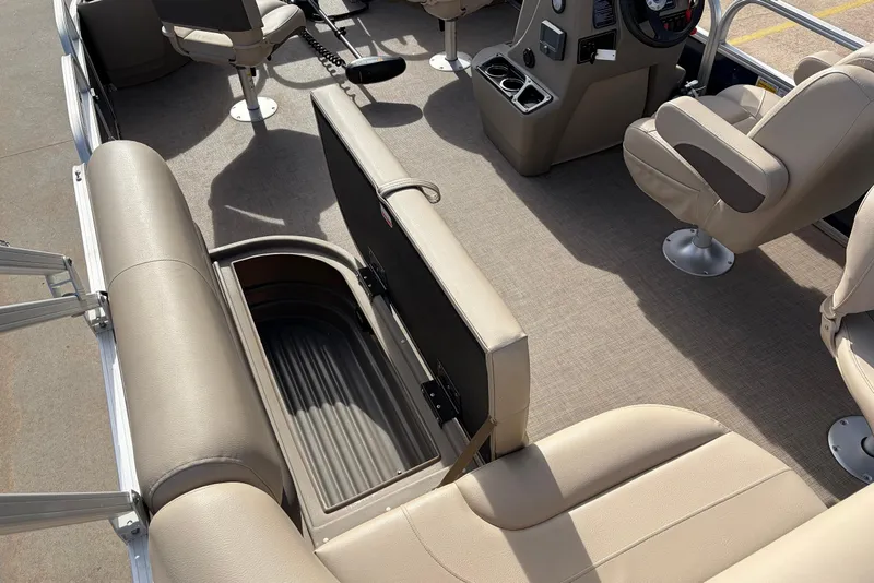 Slide: The Image of 2025 Sun Tracker Bass Buggy 18 DLX interior with beige seating and storage compartment. - 21