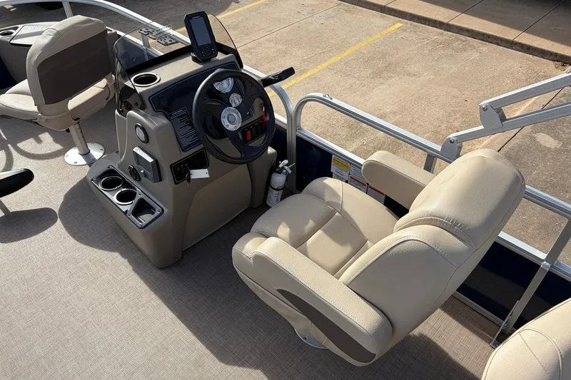 Slide: The Image of 2025 Sun Tracker Bass Buggy 18 DLX boat interior with steering console and seating. - 23