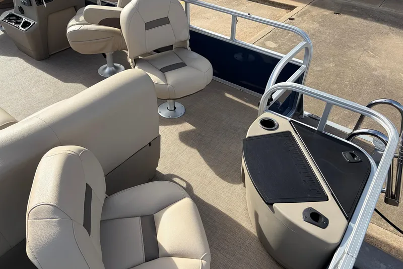 Slide: The Image of 2025 Sun Tracker Bass Buggy 18 DLX interior with beige seating and fishing station. - 31