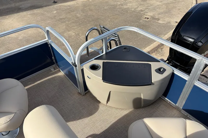 Slide: The Image of 2025 Sun Tracker Bass Buggy 18 DLX pontoon boat interior with seating and motor. - 32