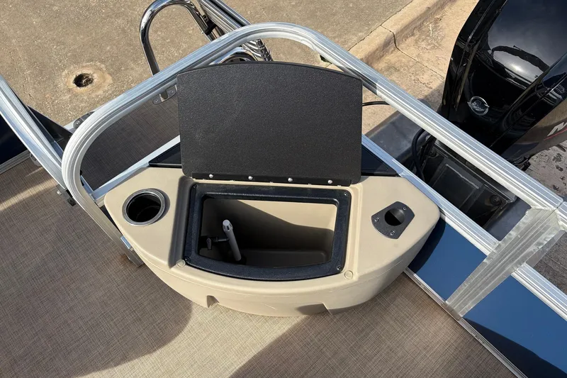 Slide: The Image of 2025 Sun Tracker Bass Buggy 18 DLX boat with open storage compartment and cup holder. - 33