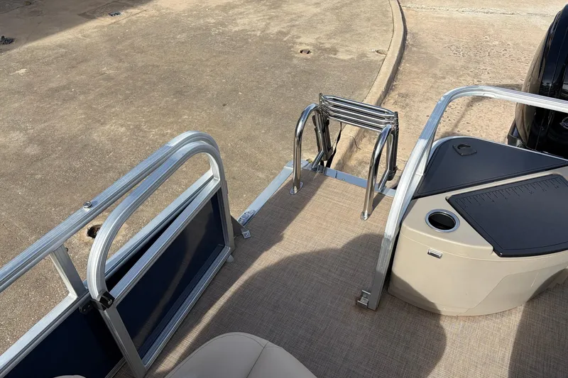 Slide: The Image of 2025 Sun Tracker Bass Buggy 18 DLX pontoon boat with ladder and seating area. - 34