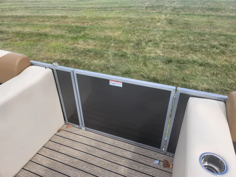 Slide: The Image of 2022 Lowe SS 210 CL boat interior with beige seating and wooden deck. - 11