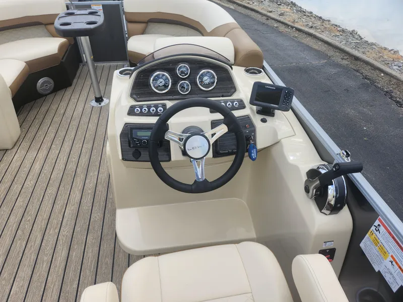 Slide: The Image of 2022 Lowe SS 210 CL boat interior with steering wheel and dashboard controls. - 17