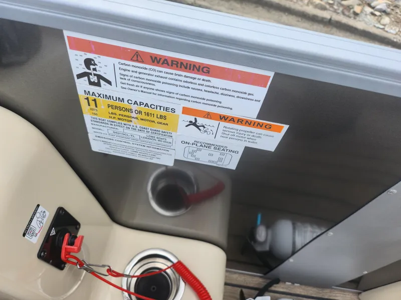 Slide: The Image of Warning labels on 2022 Lowe SS 210 CL boat, showing maximum capacity and safety instructions. - 18