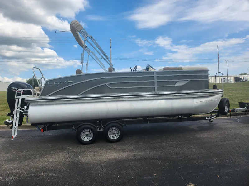 Slide: The Image of 2022 Lowe SS 210 CL pontoon boat on trailer under blue sky. - 4