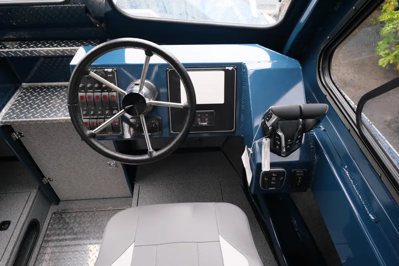 Slide: The Image of 2025 Hewescraft 270 Alaskan boat interior with steering wheel and control panel. - 14