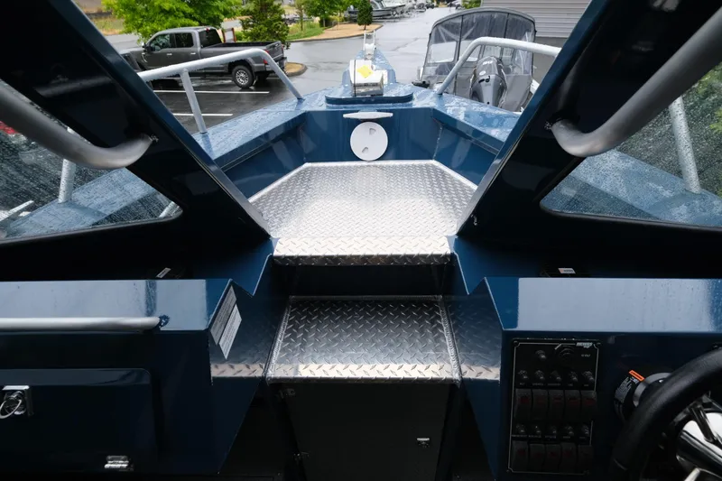 Slide: The Image of Interior view of 2025 Hewescraft 270 Alaskan boat, featuring sleek design and control panel. - 16