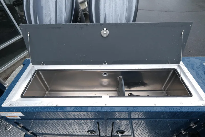 Slide: The Image of Open storage compartment on 2025 Hewescraft 270 Alaskan boat, featuring a sleek metal interior. - 22