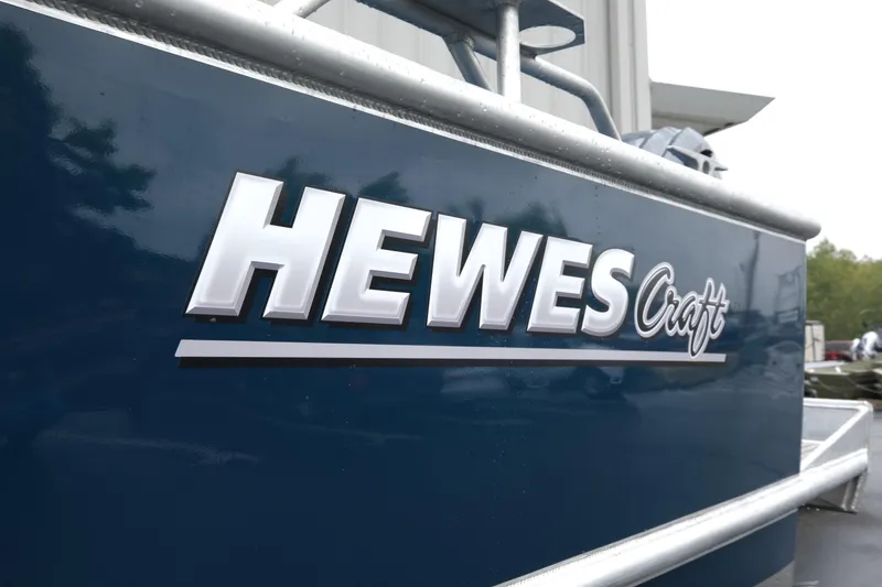 Slide: The Image of 2025 Hewescraft 270 Alaskan boat with logo on blue hull. - 23