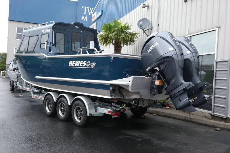Slide: The Image of 2025 Hewescraft 270 Alaskan boat with dual Yamaha engines on a trailer. - 5