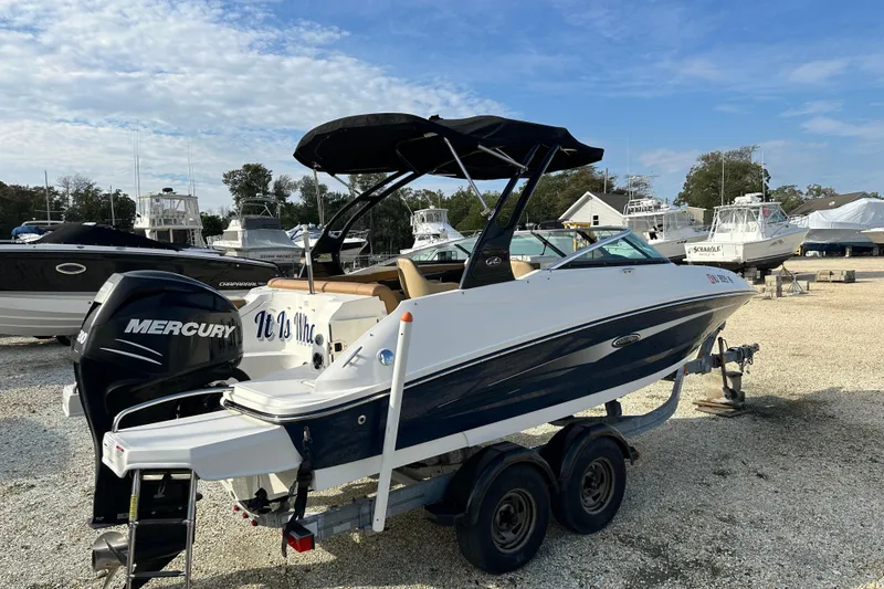 Slide: The Image of 2015 Sea Ray 220 Sundeck Outboard boat with Mercury engine on trailer. - 1