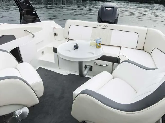 Slide: The Image of Manufacturer Provided Image: 2015 Sea Ray 220 Sundeck Outboard boat interior with seating and table. - 10