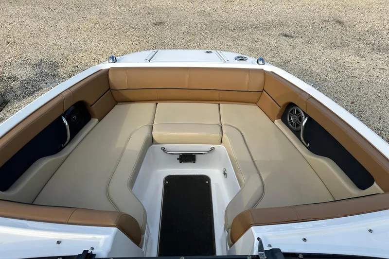 Slide: The Image of 2015 Sea Ray 220 Sundeck Outboard interior with tan seating and speaker system. - 19