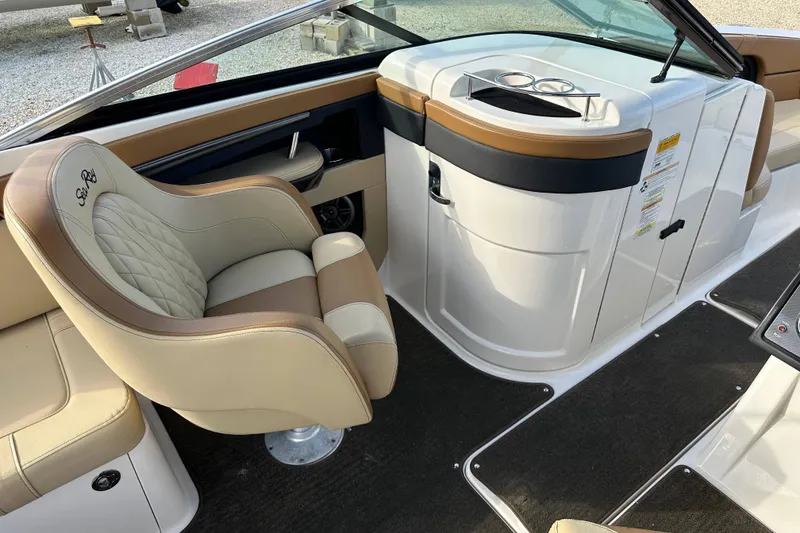 Slide: The Image of 2015 Sea Ray 220 Sundeck Outboard interior with luxurious seating and helm station. - 21
