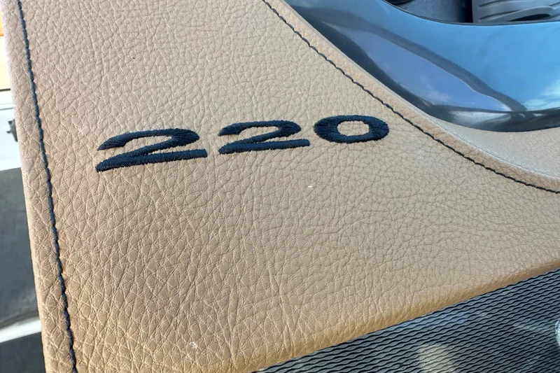 Slide: The Image of Close-up of 2015 Sea Ray 220 Sundeck Outboard leather detailing. - 22