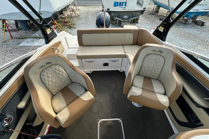 Slide: The Image of 2015 Sea Ray 220 Sundeck Outboard interior with beige and brown seating. - 3