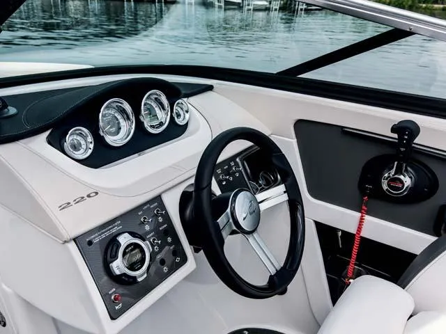 Slide: The Image of Manufacturer Provided Image: 2015 Sea Ray 220 Sundeck Outboard dashboard and steering wheel, docked by the water. - 8