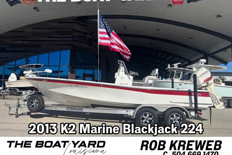 The Image of 2013 BlackJack 224 boat on trailer at The Boat Yard, Louisiana, with American flag. - 0