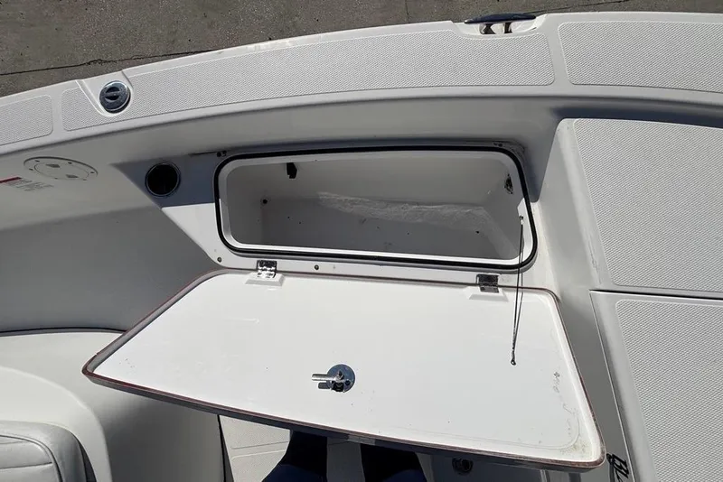 Slide: The Image of Open storage compartment on 2013 BlackJack 224 boat deck. - 12
