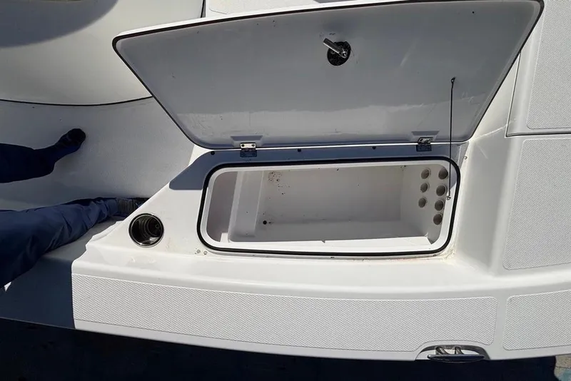 Slide: The Image of Open storage compartment on a 2013 BlackJack 224 boat deck. - 14