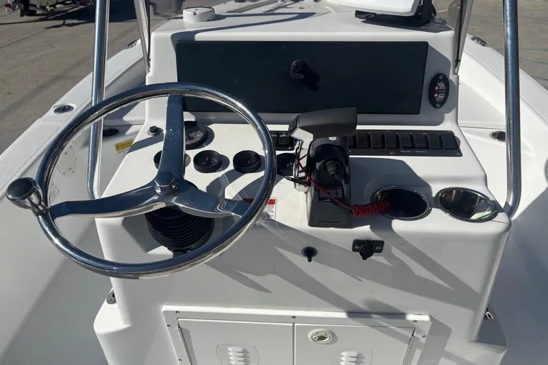 Slide: The Image of Steering console of a 2013 BlackJack 224 boat with controls and gauges. - 16