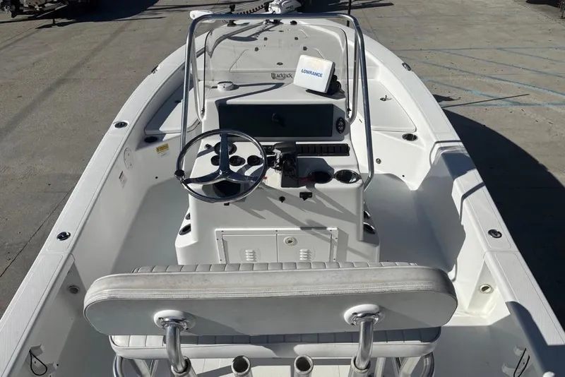 Slide: The Image of 2013 BlackJack 224 boat interior with steering wheel and control panel. - 17