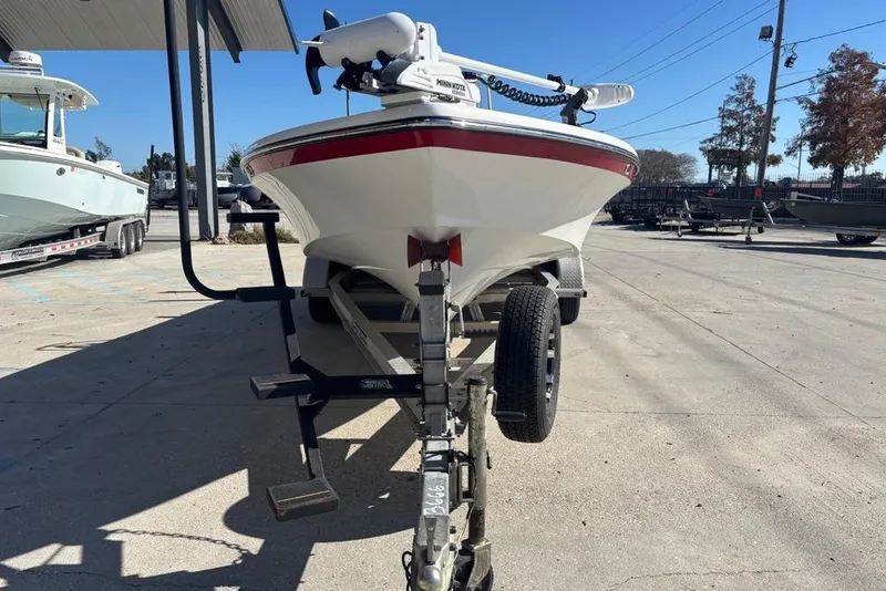 Slide: The Image of 2013 BlackJack 224 boat on trailer in outdoor storage area. - 2