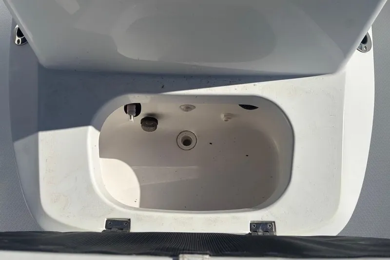 Slide: The Image of Open storage compartment in a 2013 BlackJack 224 boat. - 21