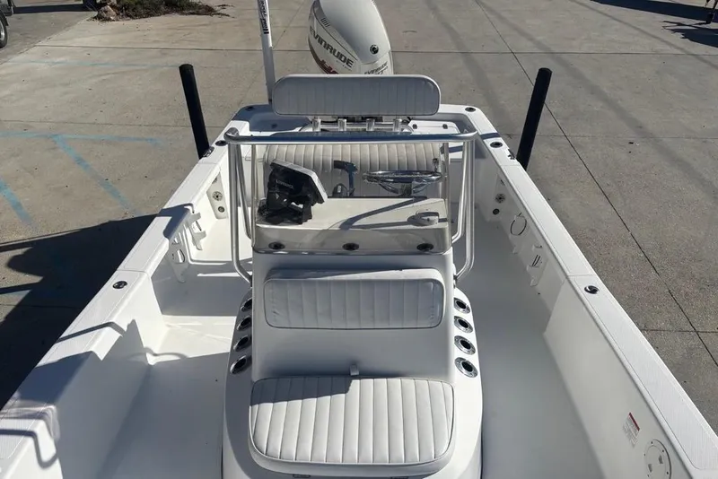Slide: The Image of 2013 BlackJack 224 boat interior with white seating and steering console. - 22