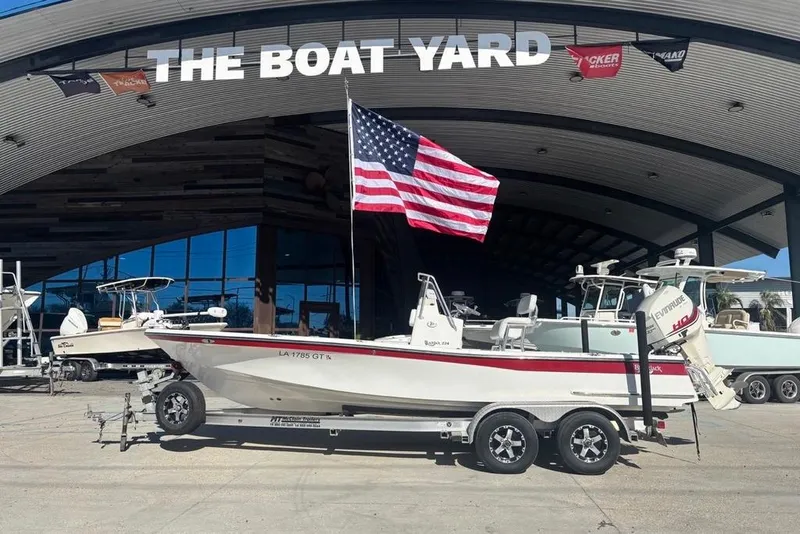 Slide: The Image of 2013 BlackJack 224 boat with American flag at The Boat Yard dealership. - 25