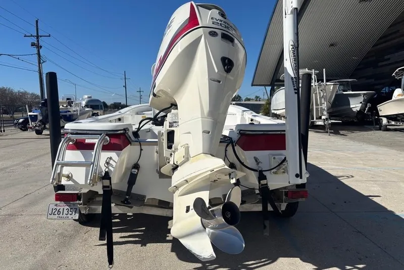 Slide: The Image of Rear view of 2013 BlackJack 224 boat with Evinrude motor in a marina. - 6