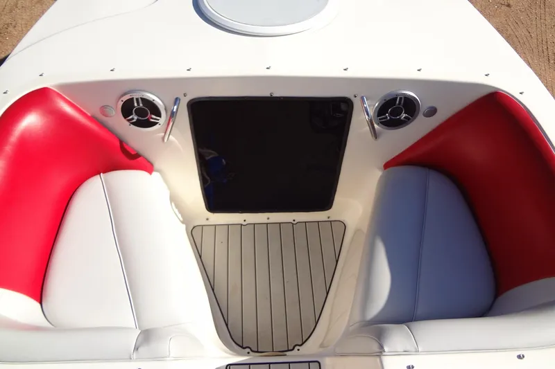 Slide: The Image of 2003 Ski Centurion Tsunami boat interior with red and white seating, speakers, and flooring. - 11