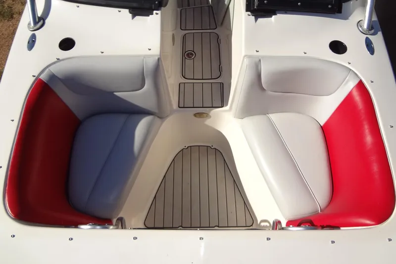 Slide: The Image of 2003 Ski Centurion Tsunami boat interior with red and gray seating, wooden flooring. - 12