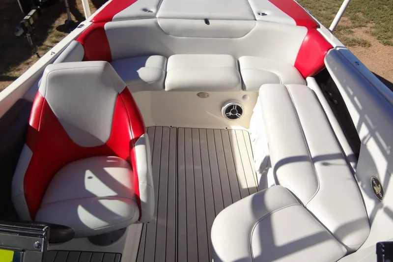 Slide: The Image of 2003 Ski Centurion Tsunami boat interior with red and white seating, spacious layout. - 15