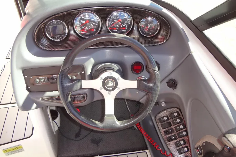 Slide: The Image of 2003 Ski Centurion Tsunami dashboard with steering wheel and instrument panel. - 17