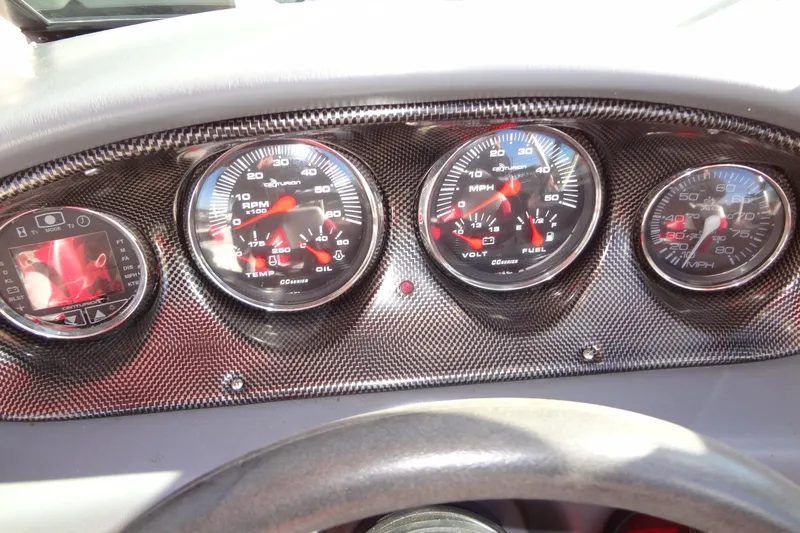 Slide: The Image of Dashboard of a 2003 Ski Centurion Tsunami boat with carbon fiber finish and gauges. - 18