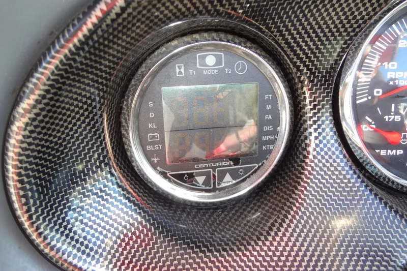 Slide: The Image of 2003 Ski Centurion Tsunami dashboard with digital display and carbon fiber finish. - 19