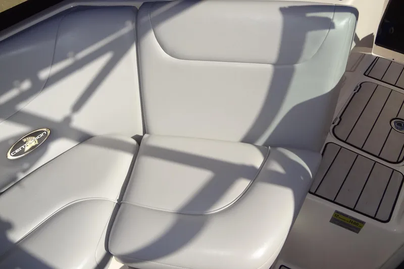Slide: The Image of 2003 Ski Centurion Tsunami boat interior with white cushioned seating and logo detail. - 22