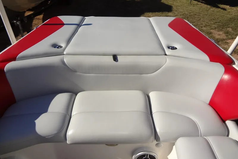 Slide: The Image of 2003 Ski Centurion Tsunami boat interior with red and gray cushioned seating. - 24